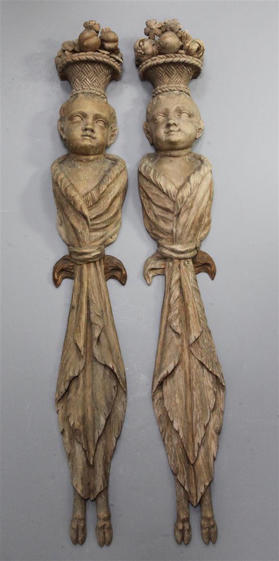 A pair of 19th century Flemish carved pine wall appliqués, 37in.